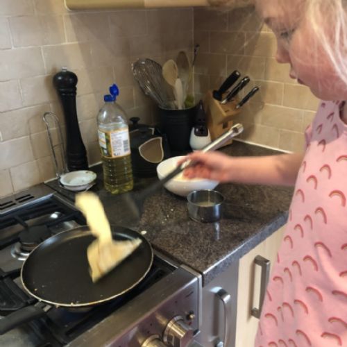 Sophie cooking pancakes for her breakfast. 